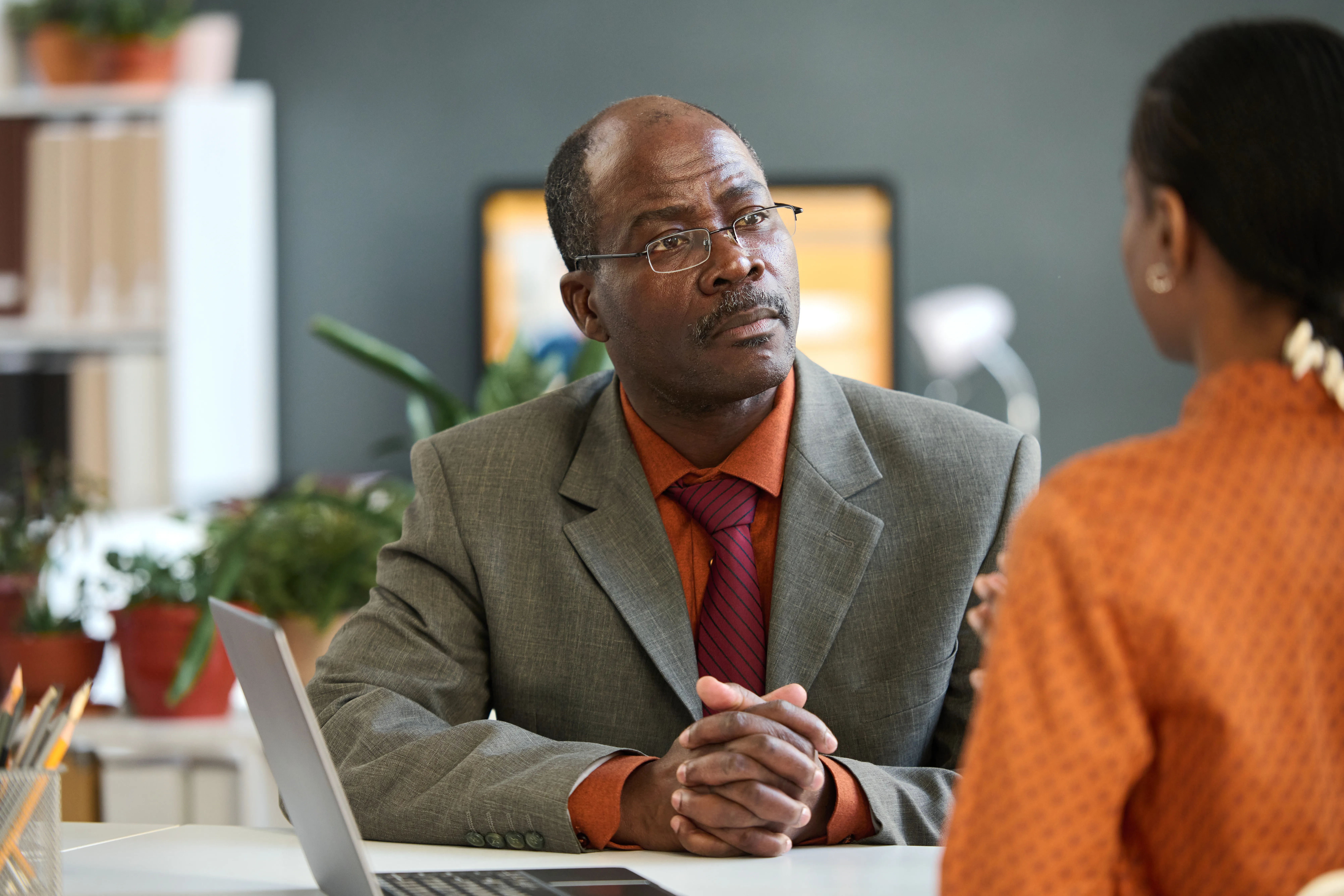 Senior Black Businessman Listening to Young Employee